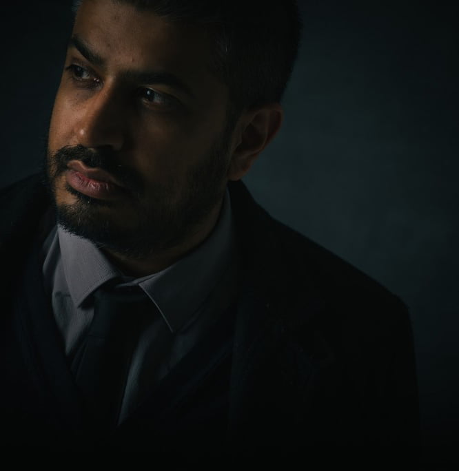 dark moody portrait of author looking out of image