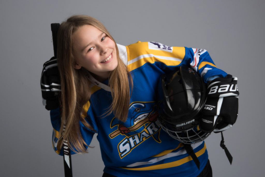 jaunty looking portrait of young female ice hockey player